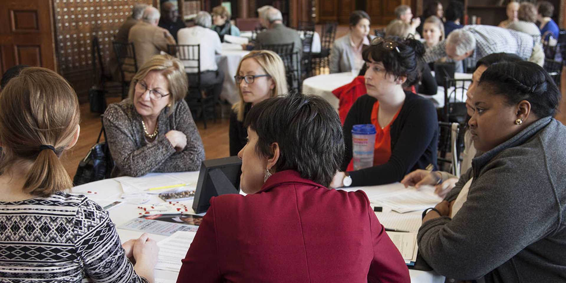 Group of women sitting at a round table in discussion