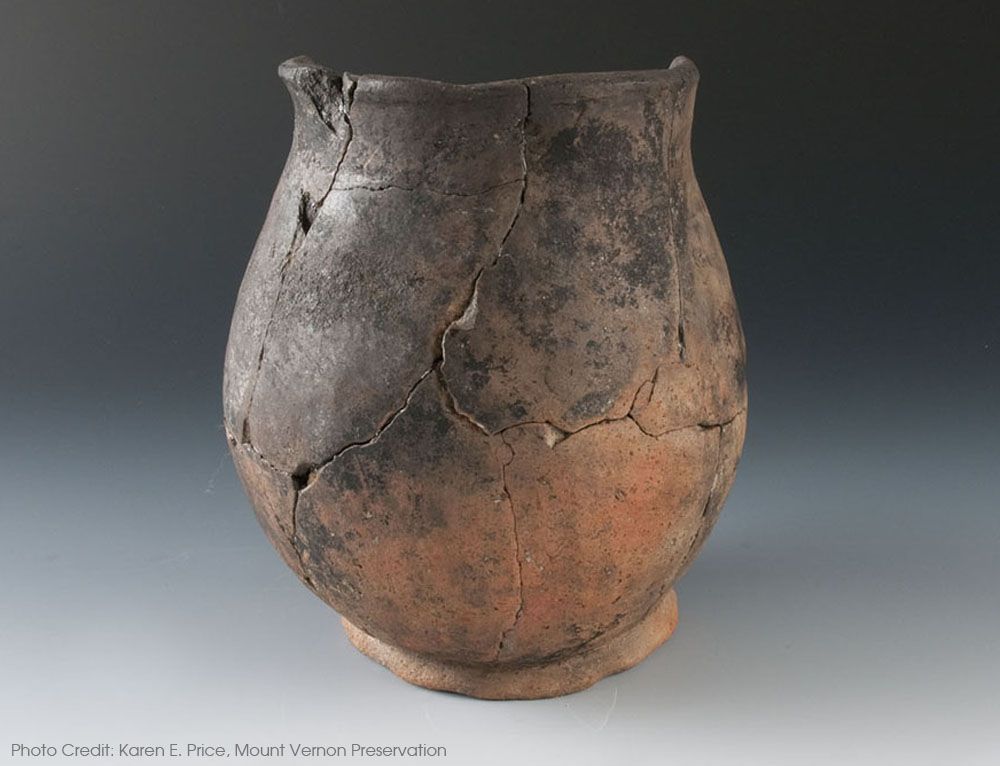 A red-brown earthenware vessel reconstructed from several shards. 