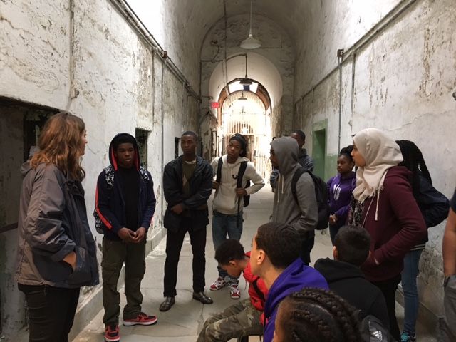 Students from  the Karabots Junior Fellows Program and the Teva Pharmaceuticals Internship Program discuss prisons wih Eastern State Penitentiary Tour Guide Lauren Bennett