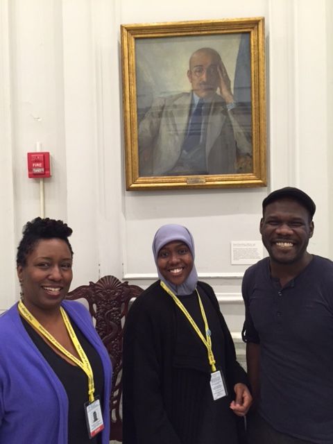 College of Physicians staff pose in front of the portrait of Dr. Nathan Francis Mossell