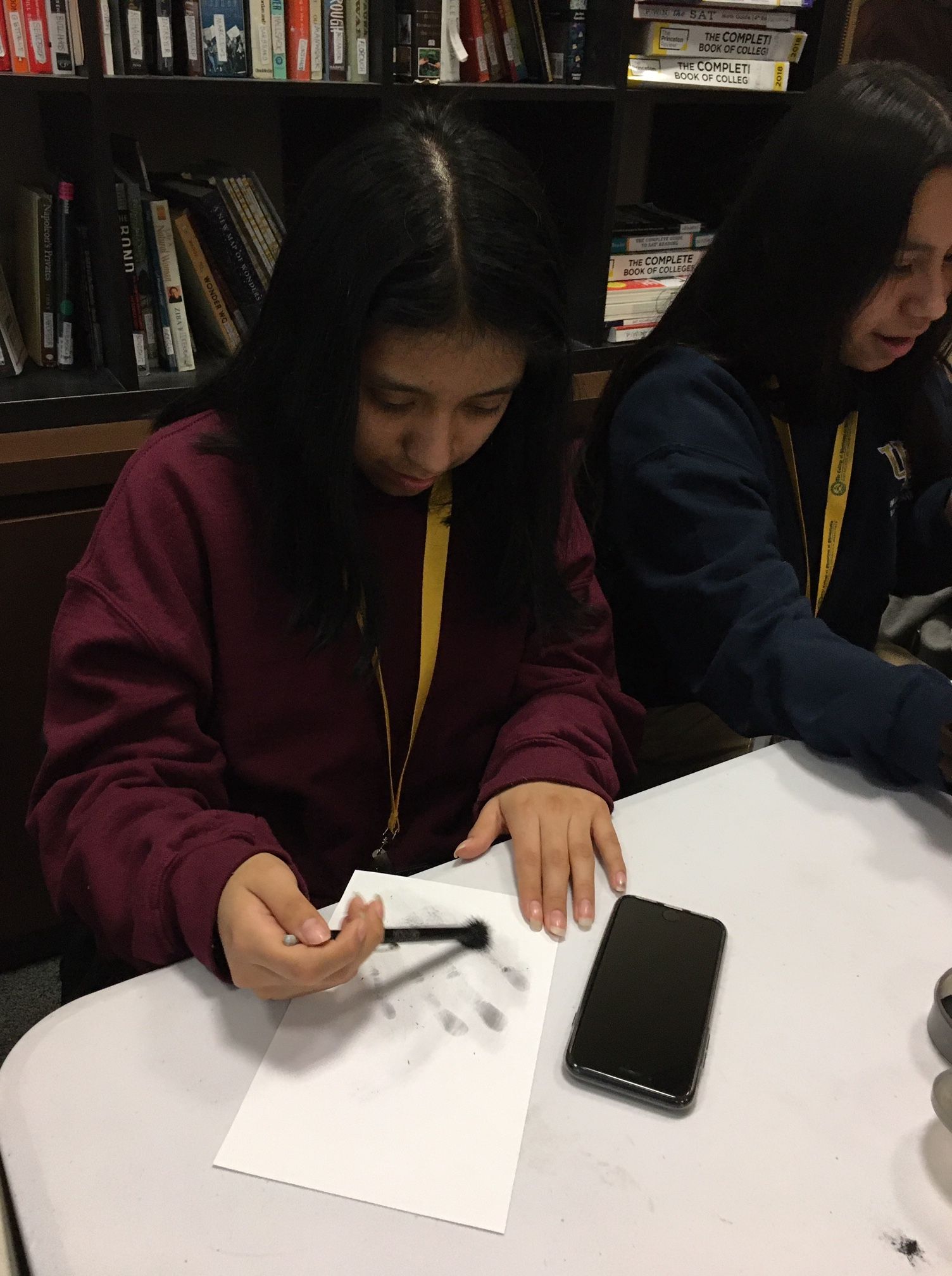 A student in the Karabots Junior Fellows Program dusts for fingerprints