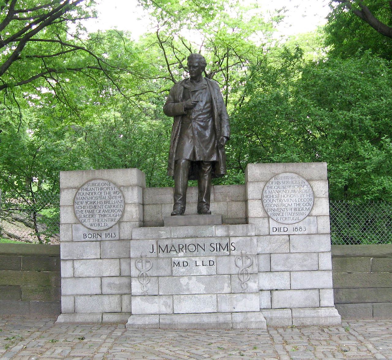 Photograph of a statue of J. Marion Sims atop a stone pedestal