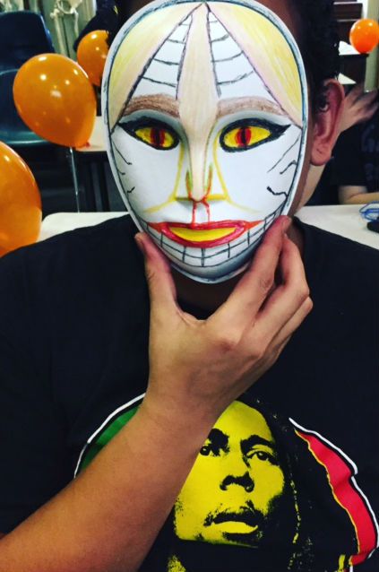 One Out4STEM student shows off a mask made at the annual Out4STEM Masquerade event, 10/29/15