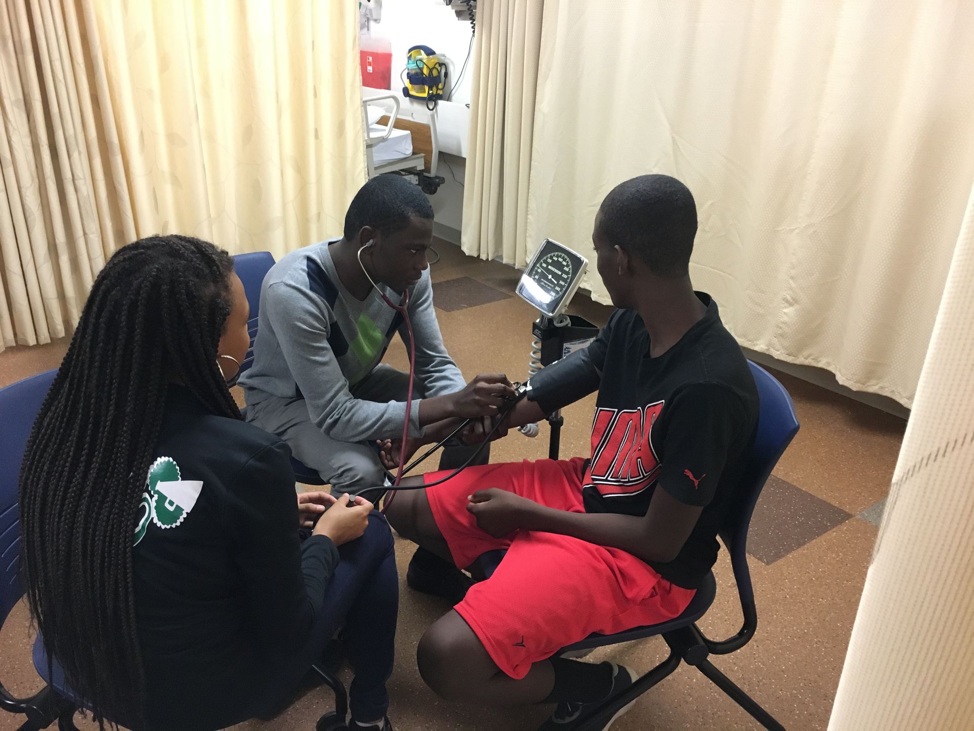 Students in the KArabots Junior Fellows Program monitor each other's blood pressure at Drexel University's Physical Therapy Lab