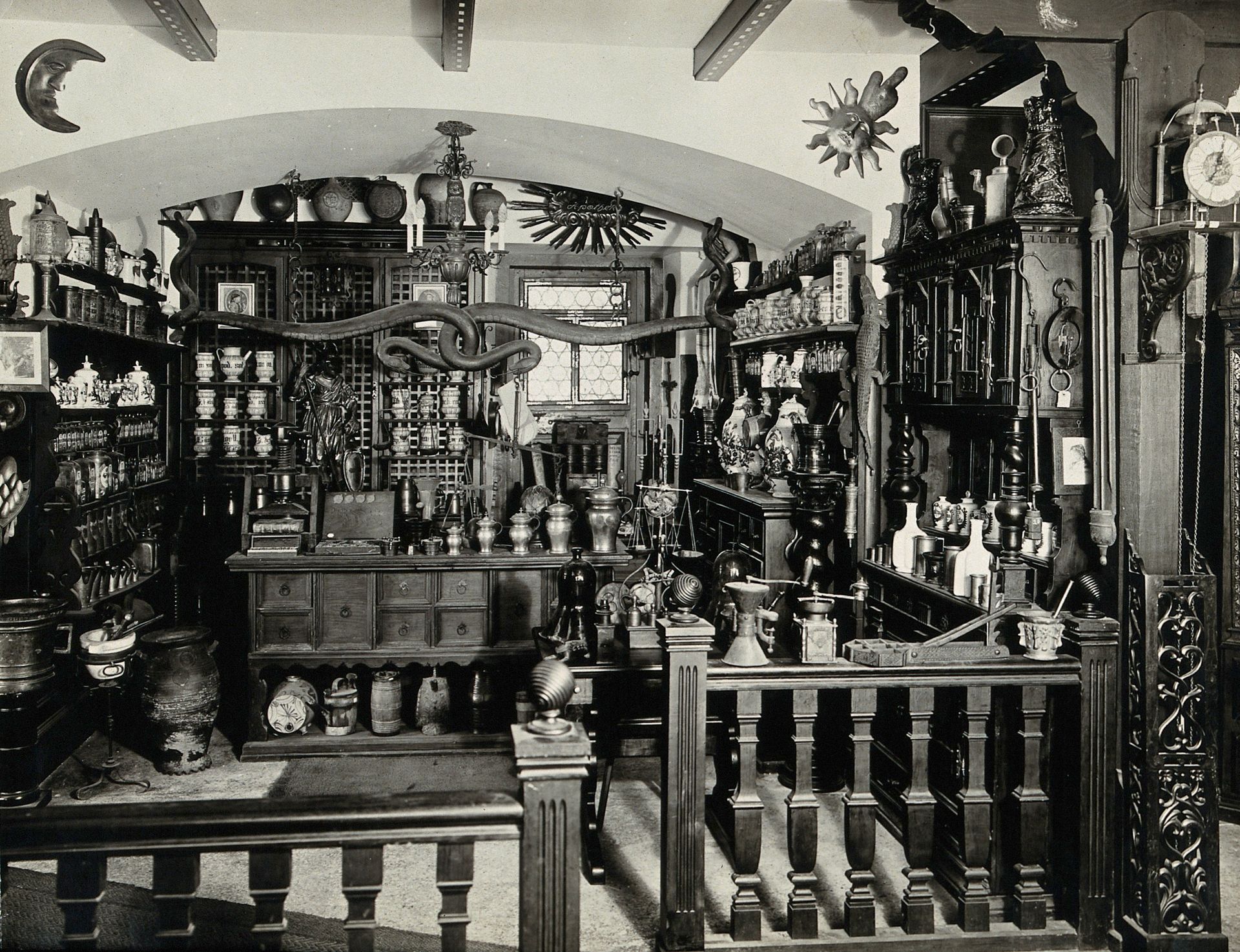 Image of an apothecary shop with various bottles and containers stacked on shevles