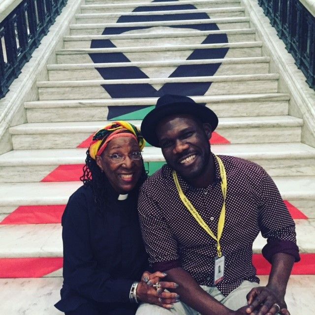 Attendees of National Black HIV/AIDS Awareness Day posing in front of the NBHAAD ribbon, 2/6/2016