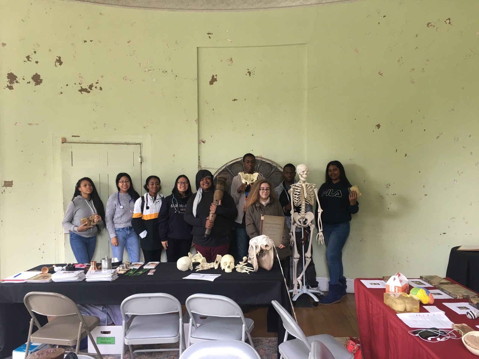 A group photo of students in the Karabots Junior Fellows Program in the Hamilton mansion at the Woodlands Cemetery