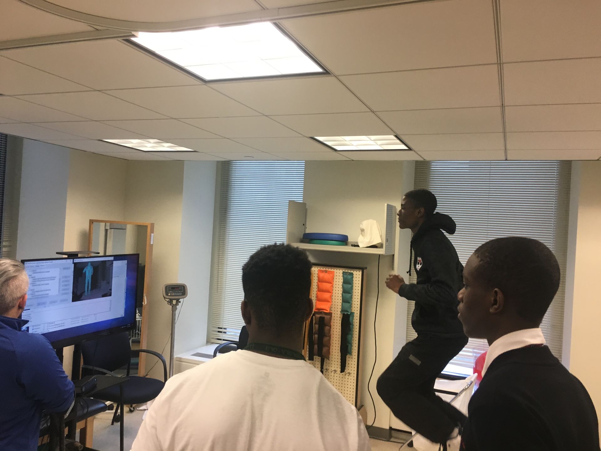 A student in the Karabots Junior Fellows Program jumps as he plays Pac-Man using a motion-detecting sensor at National Biomechanics Day