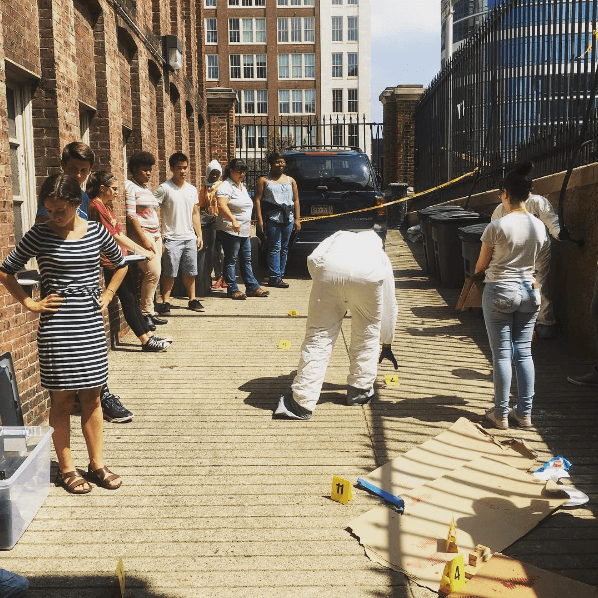 Students in the Teva Pharmaceuticals Internship Program investigate a mock crime scene at the loading dock behind the College of Physicians of Philadelphia