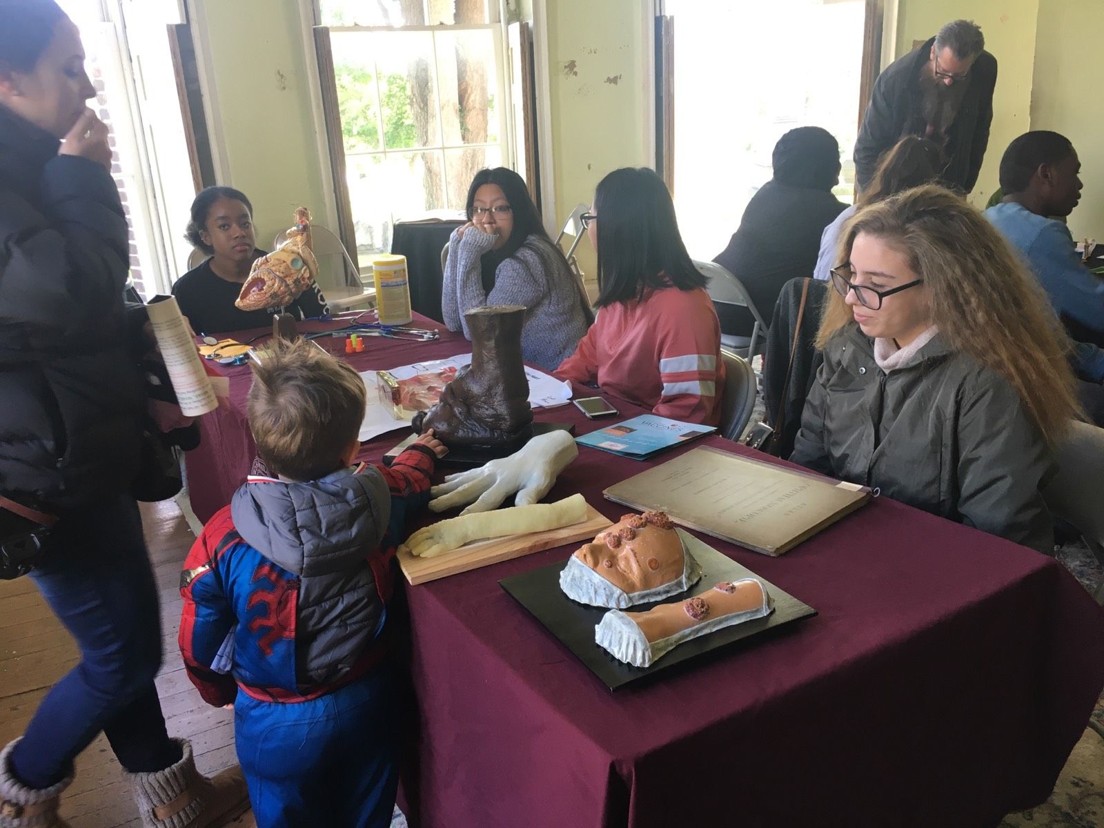Students in the Karabots Junior Fellows Program demonstrate specimens to attendees of the Halloween Family Fun Day event at the Woodlands Cemetery