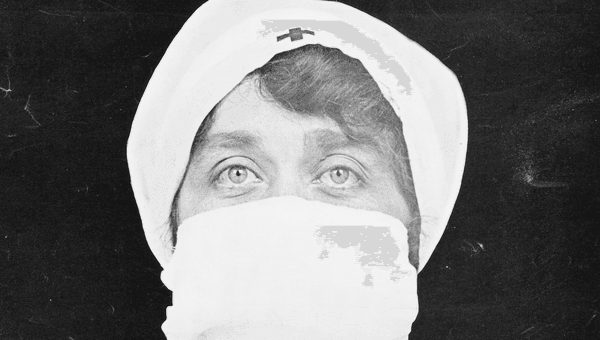 A nurse with a mask over her face.