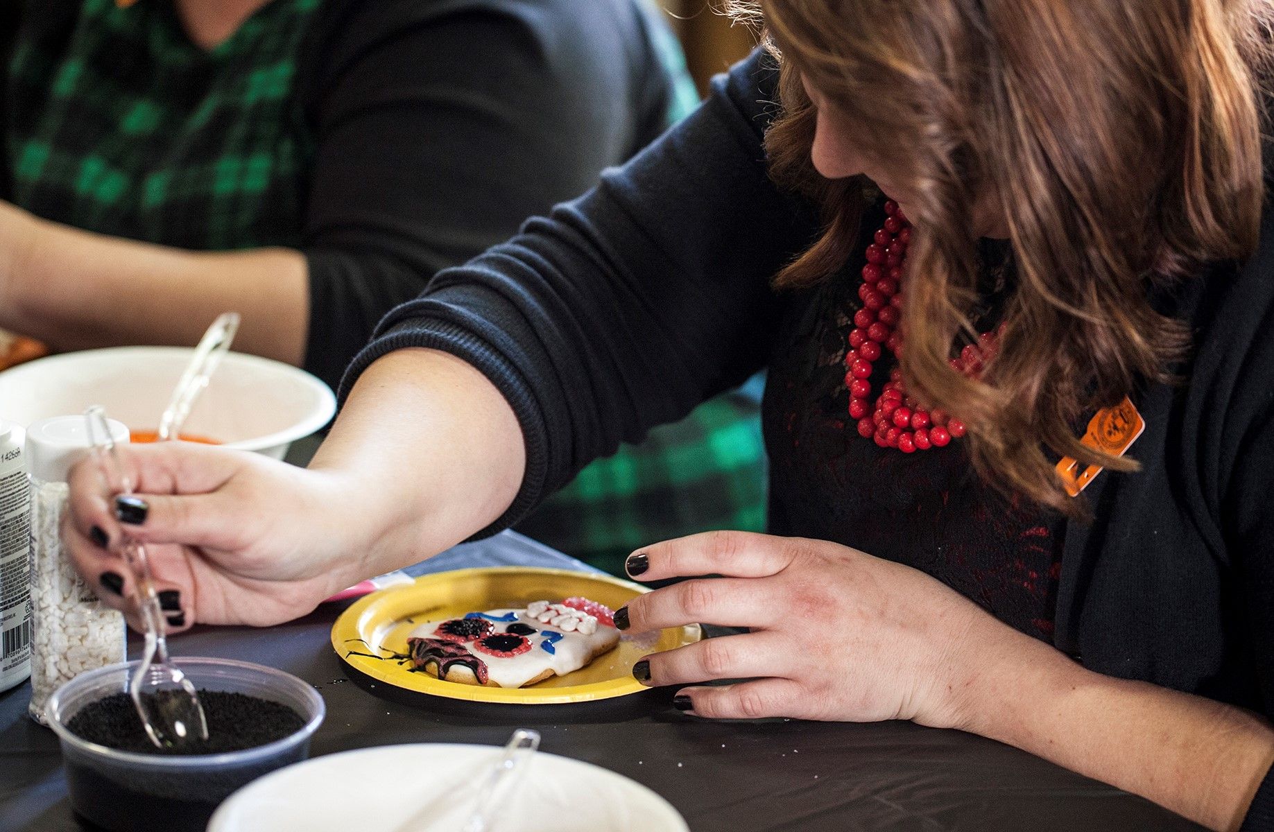 A visitor designing a sugar skull at the Mutter Museum Day of the Dead event, 10/31/15