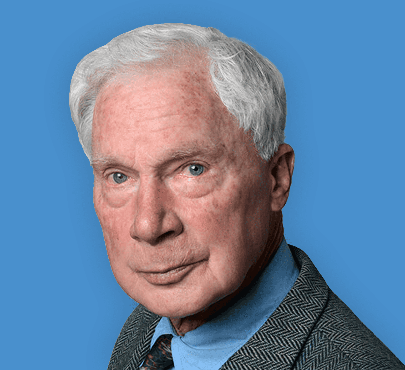 Headshot of Dr. Spaeth. A man with a gray suit and blue shirt stands against a blue background.