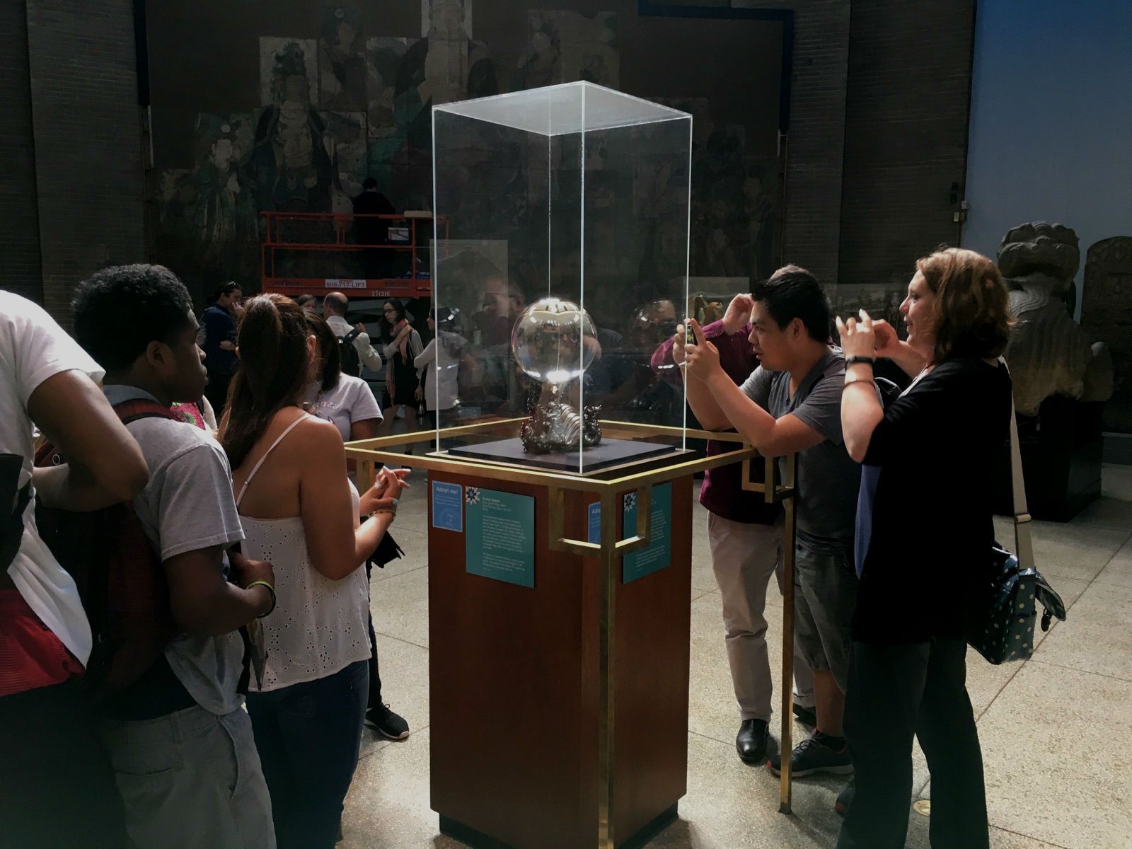 Students from the Teva Internship Program observe artifacts at the Penn Museum