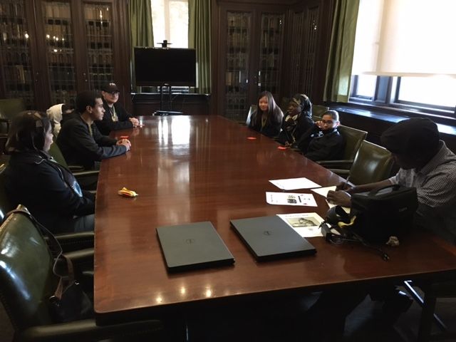 Students sit around a long table in the Gross conference room to develop a platform for their political party as part of the Project Voice 2016 event
