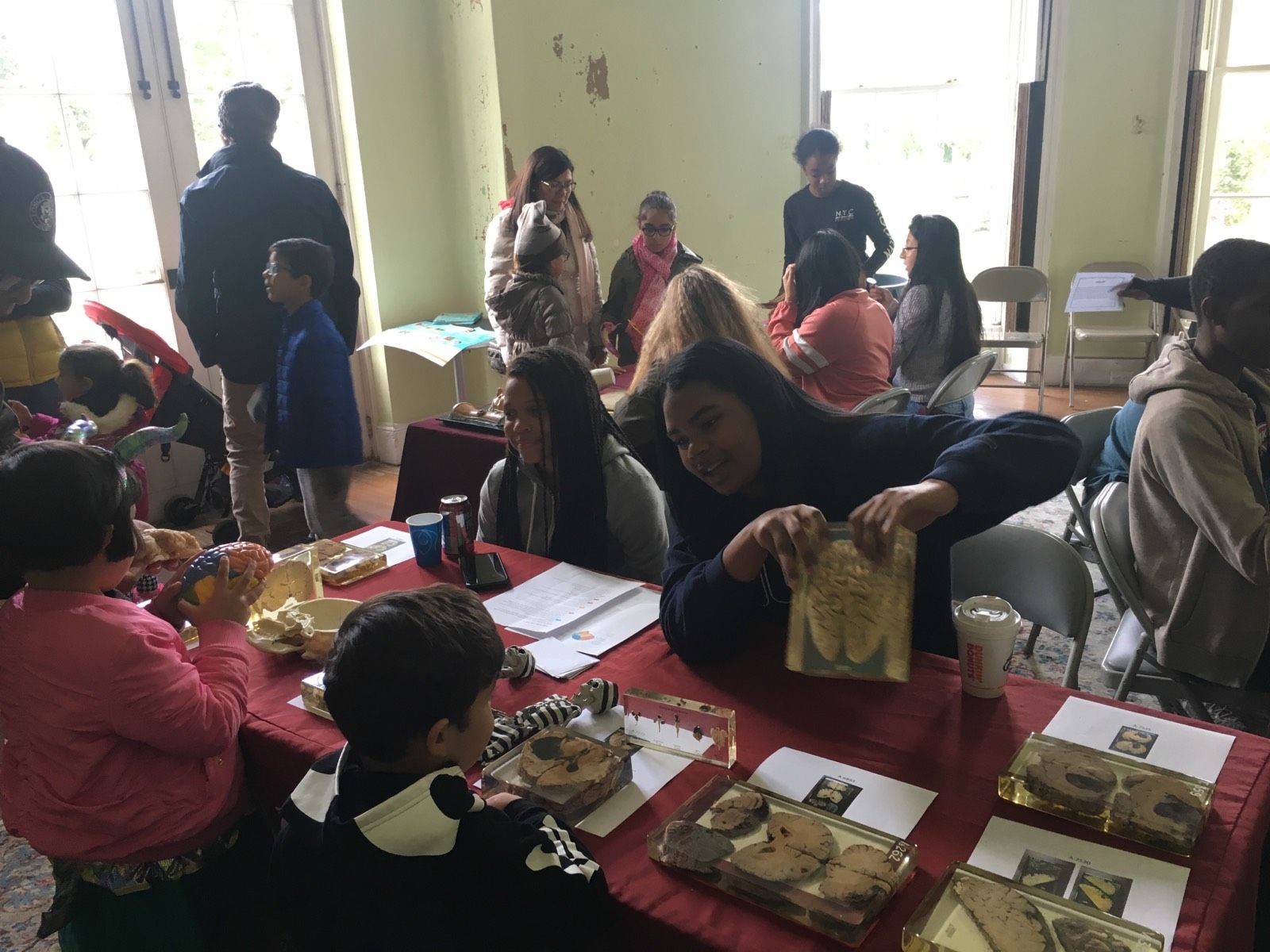 Students in the Karabots Junior Fellows Program demonstrate specimens to attendees of the Halloween Family Fun Day event at the Woodlands Cemetery