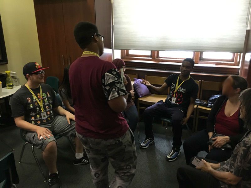 Students in the Karabots Junior Fellows Program demonstrate a card-based roleplaying game on forensics to two visitors to the Mütter Museum