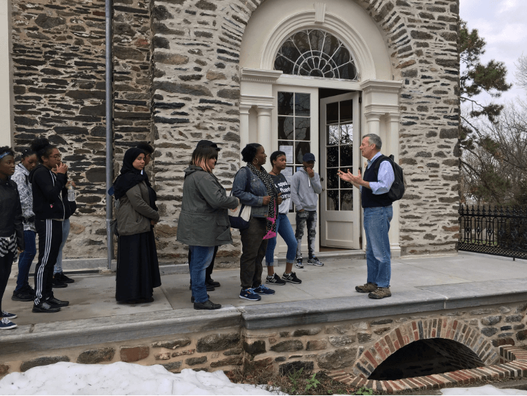 Jim Mundy delivers a tour for the Karabots Junior Fellows outside the William Hamilton mansion at the Woodlands Cemetery
