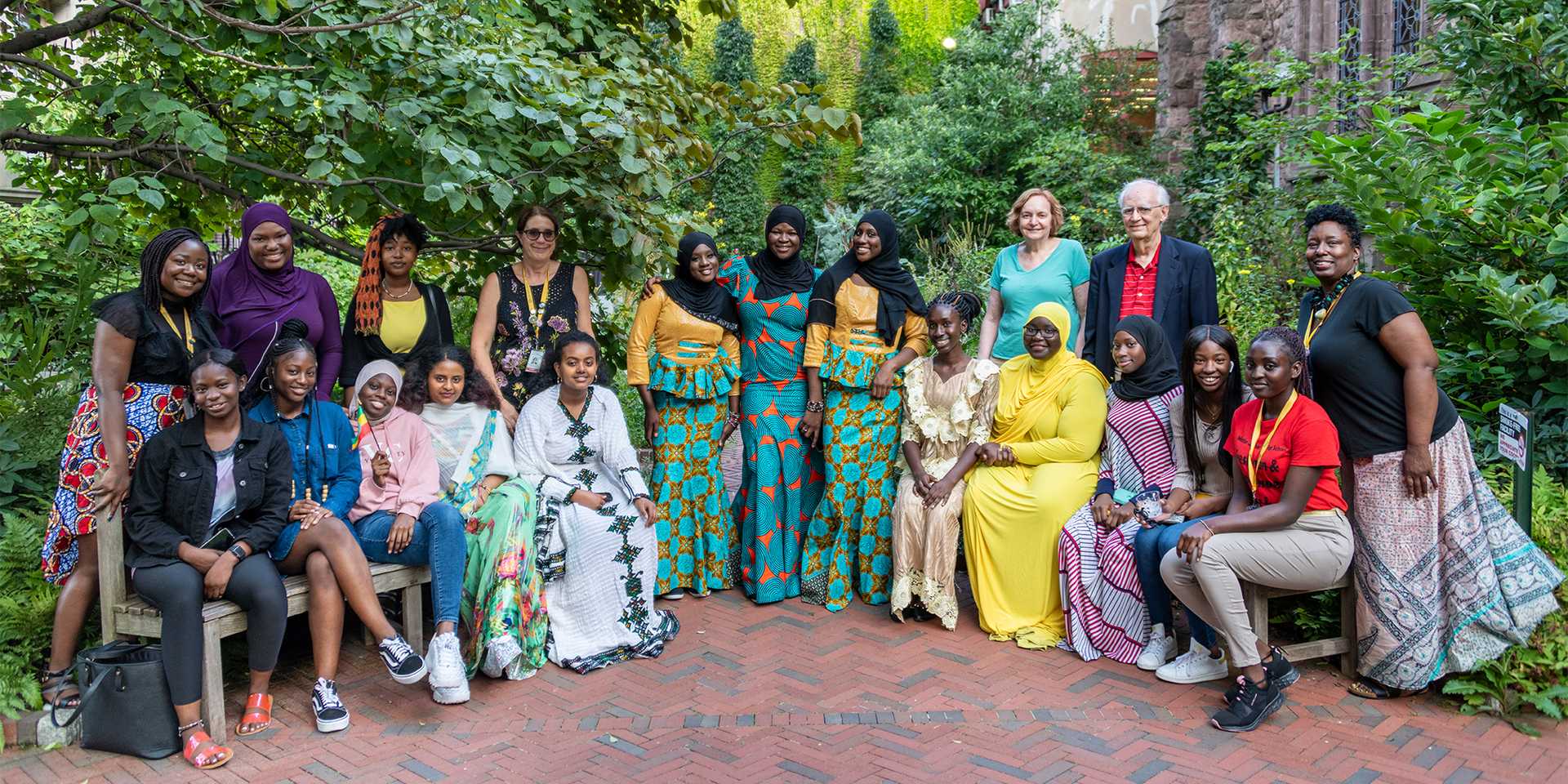 Group of women and students standing in a garden