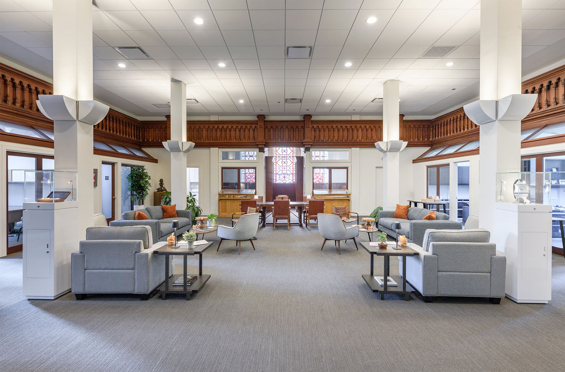 Photo of a large room with tables and chairs, couches, and side offices